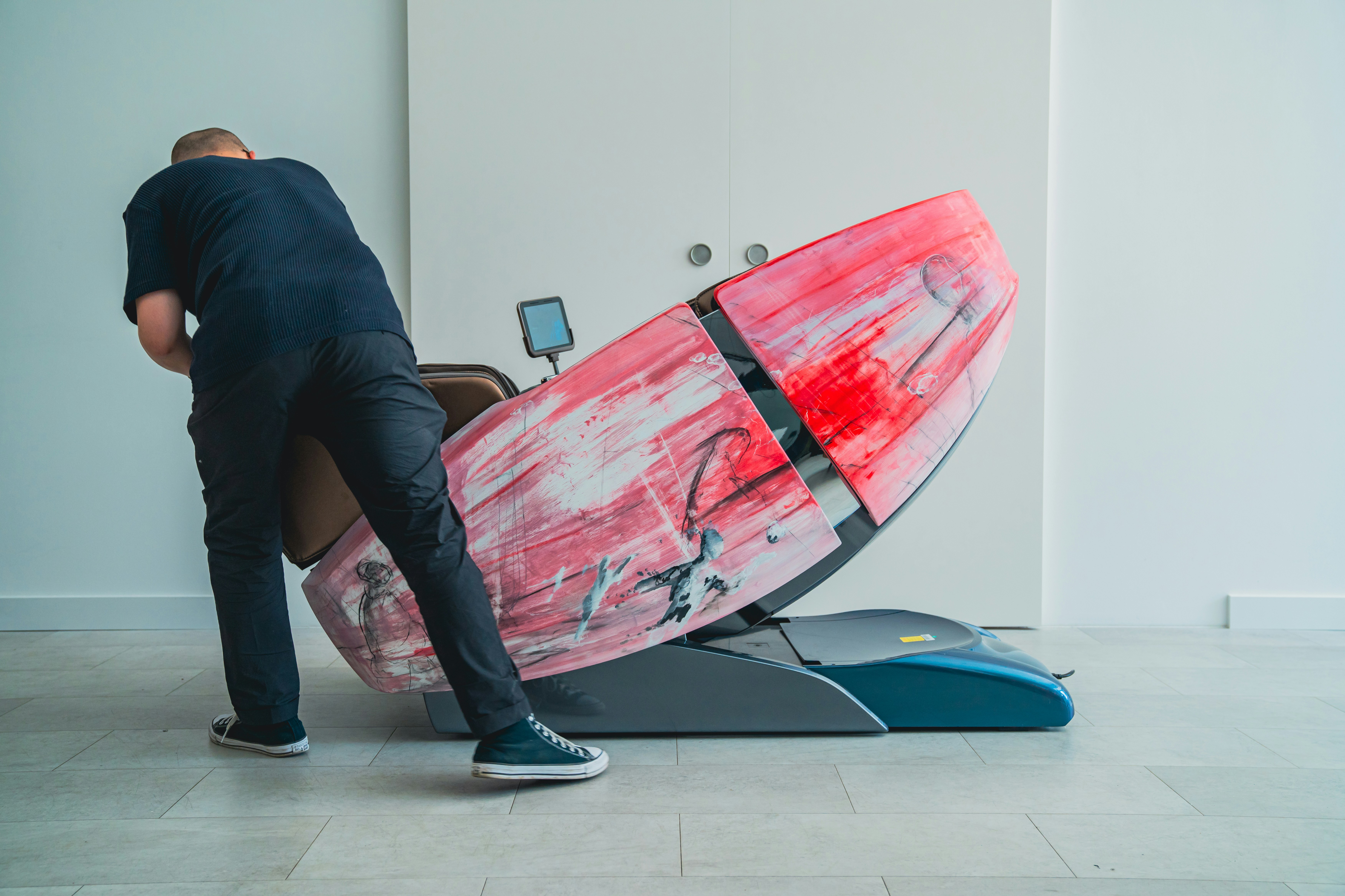 A man standing next to a surfboard in a room