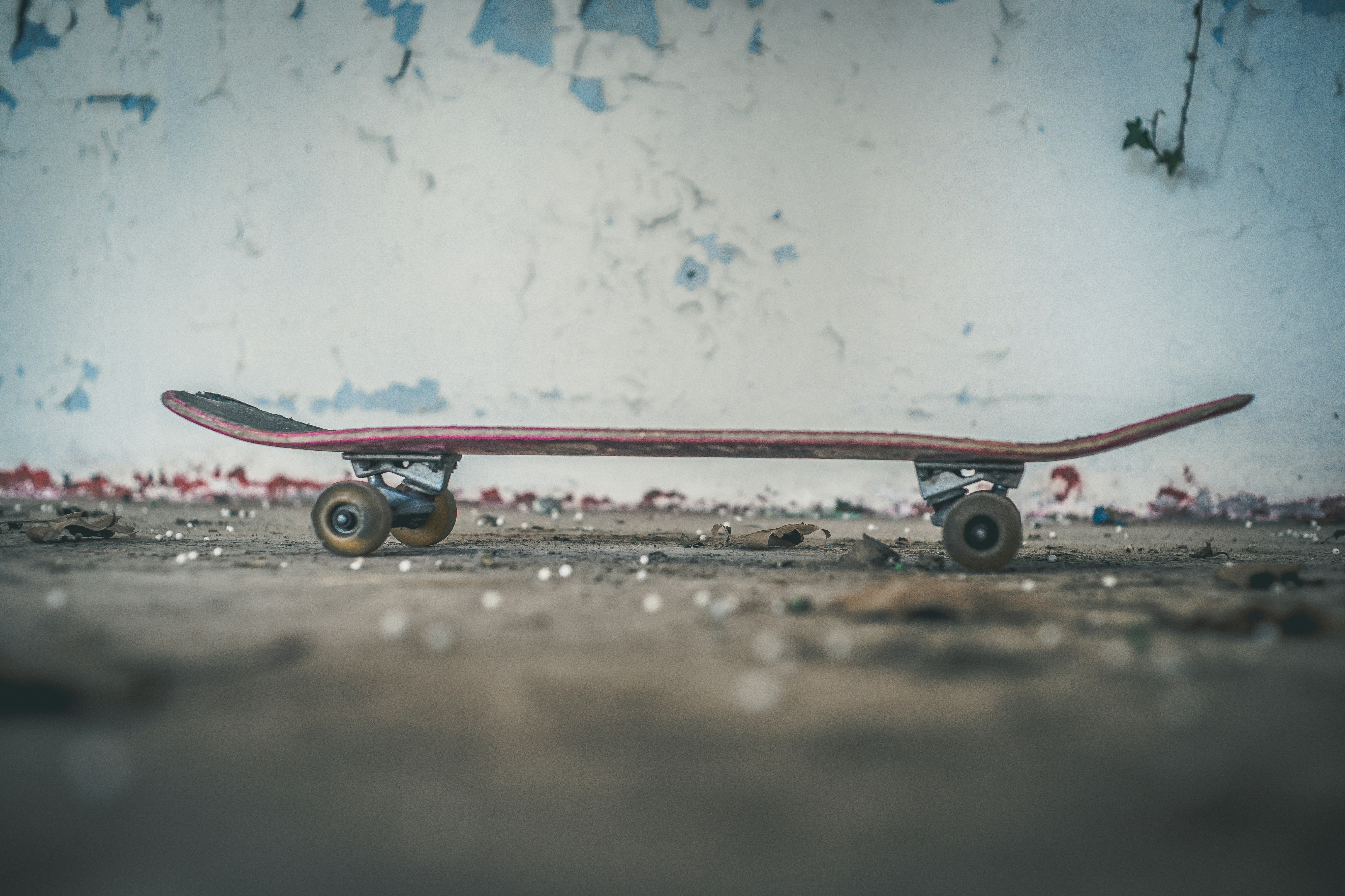 Board by Hoverboarding black skateboard near white wall