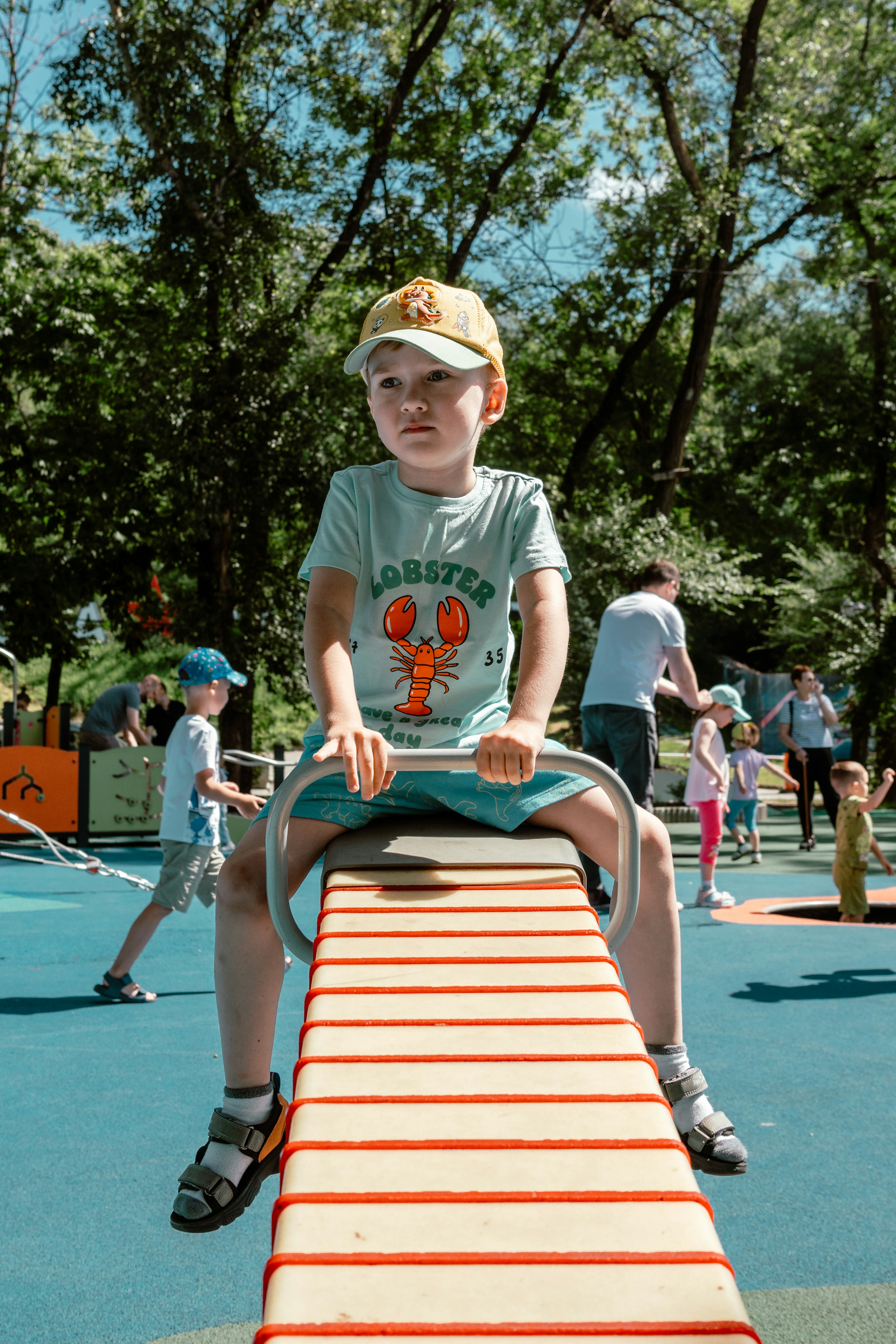 A young boy riding a bike on top of a slide