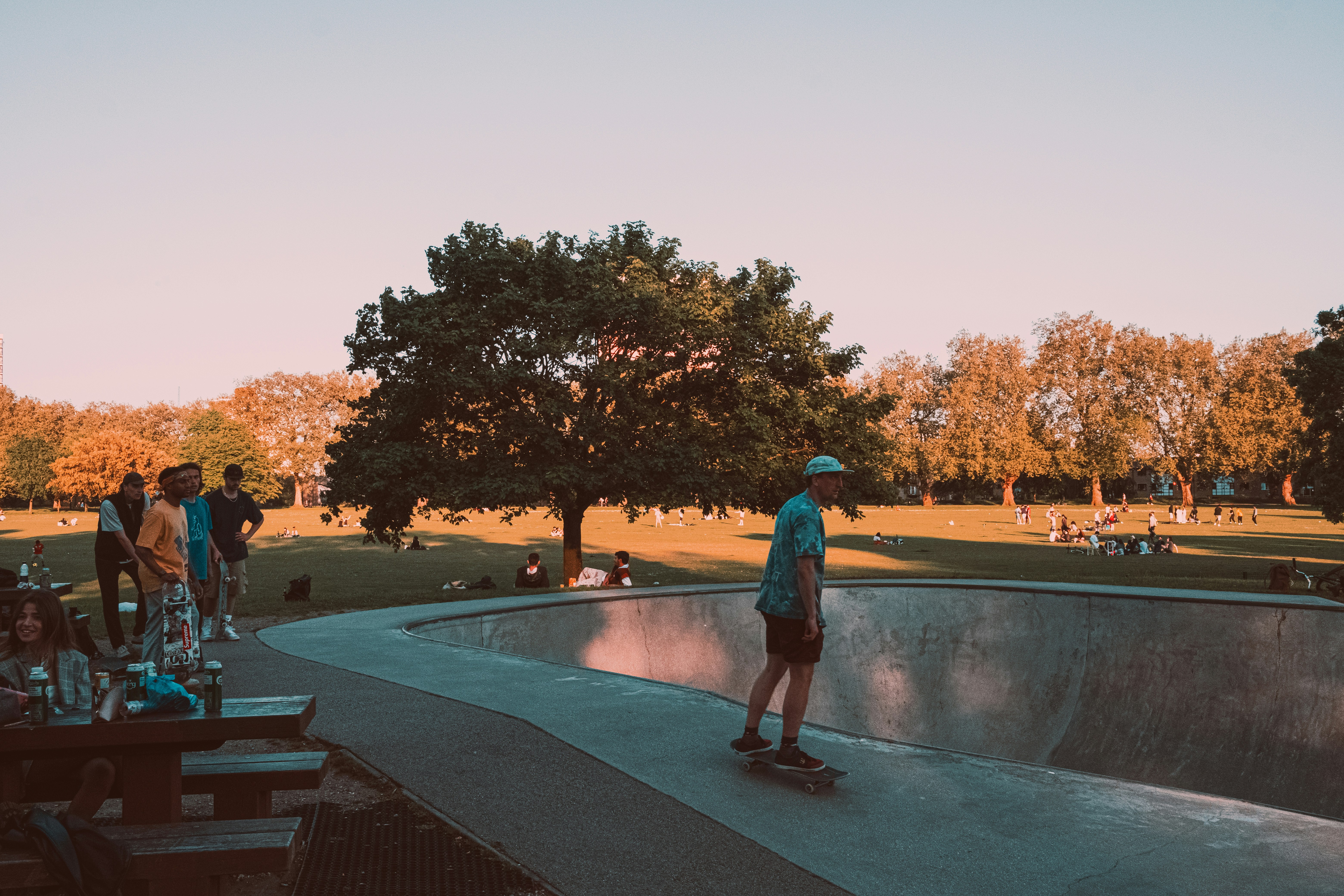 man in blue shirt and black pants walking on park during daytime
