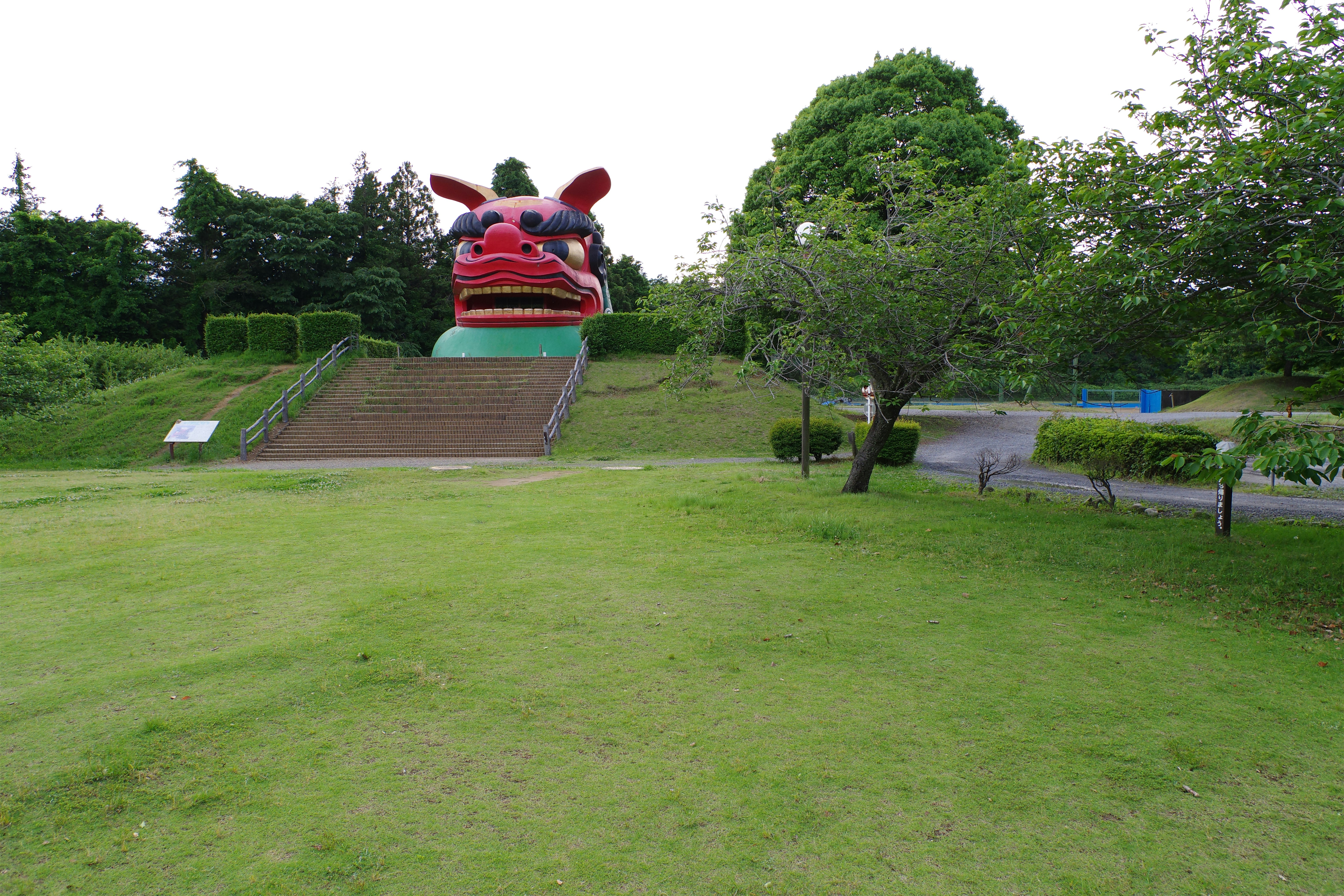 A large statue of a dog on top of a hill