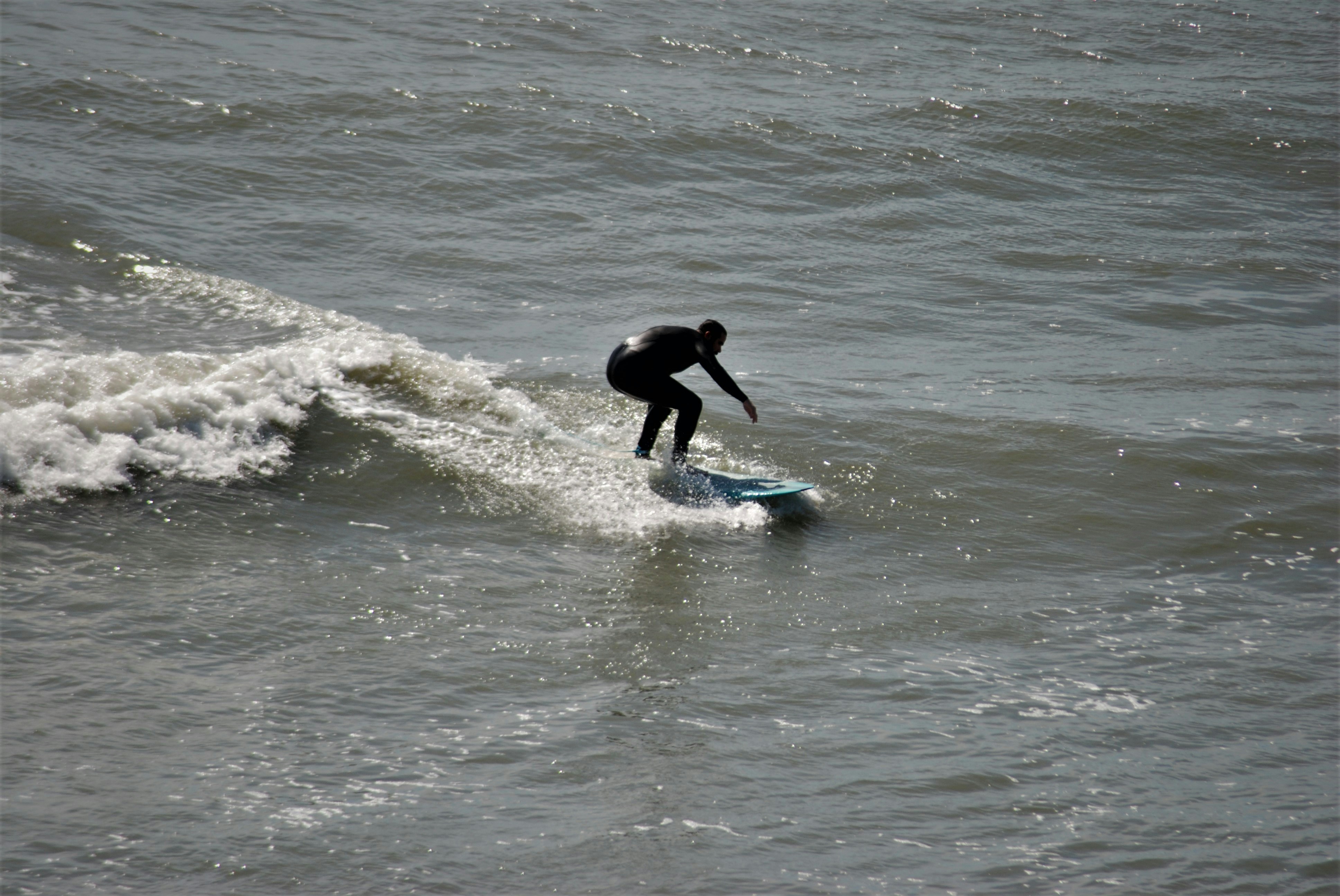 a person riding a surfboard on a wave in the ocean
