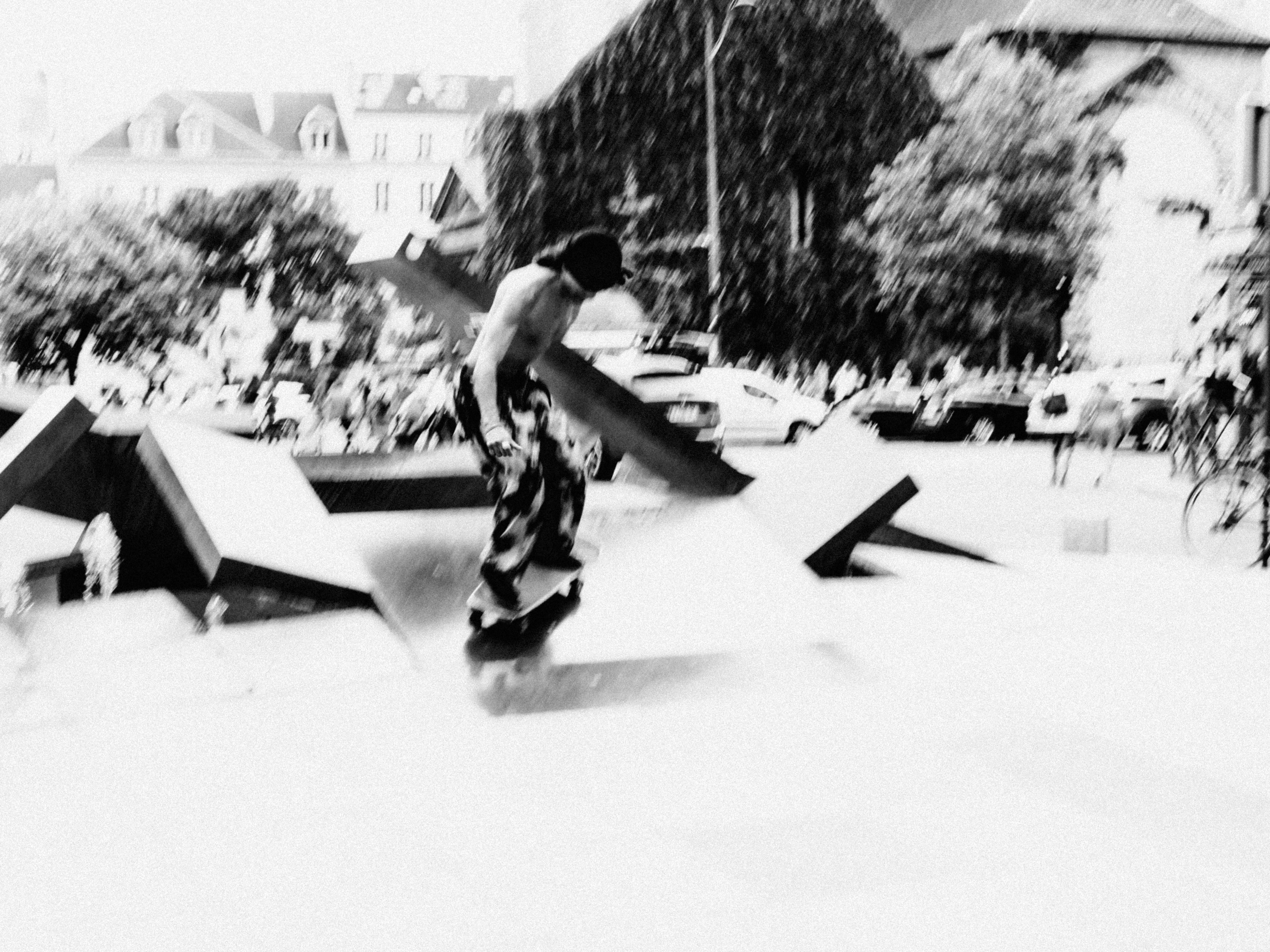 a black and white photo of a person on a skateboard