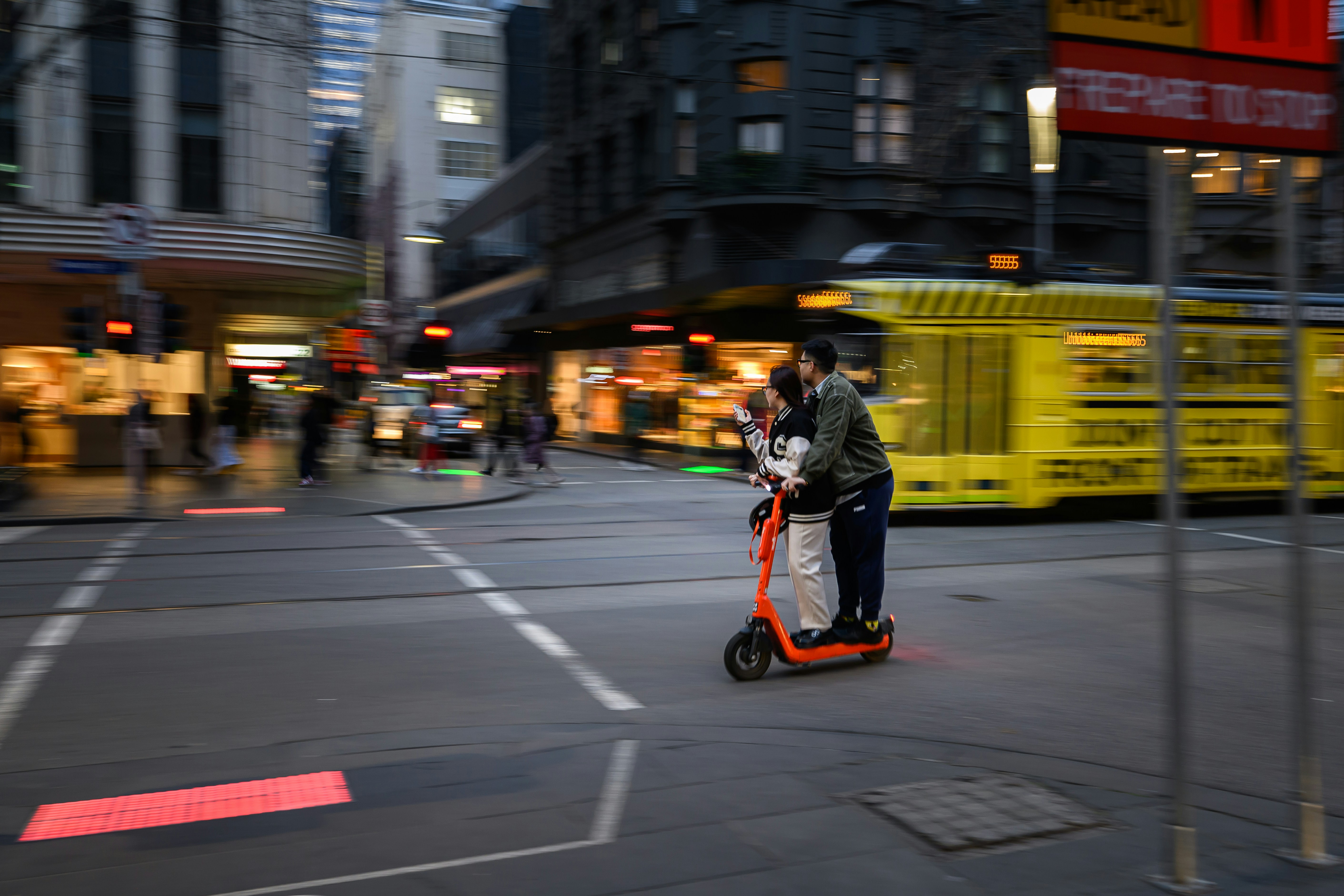 A person riding a scooter on a city street